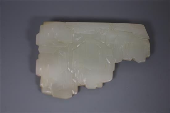 A Chinese pale celadon jade landscape carving, 19th century, W. 9cm, H. 6cm, millet and rockwork carved wood stand